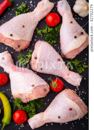 Assortment of raw chicken  breast ( fillet ) , wings and legs  with spices and herbs 82702274