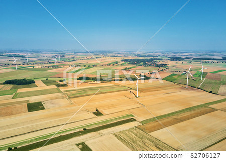 Windmill turbine in the field at summer day. Rotating wind generator 82706127