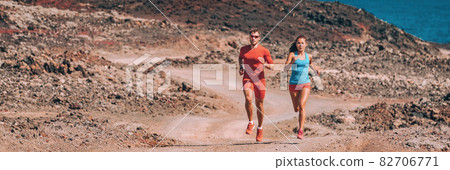 Runners training trail running fast in desert landscape panoramic banner. Couple of athletes summer outdoor sport workout. Man and woman working out together Runners training trail running fast in desert landscape panoramic banner. Couple of athletes summer outdoor sport workout. Man and woman working out together 82706771