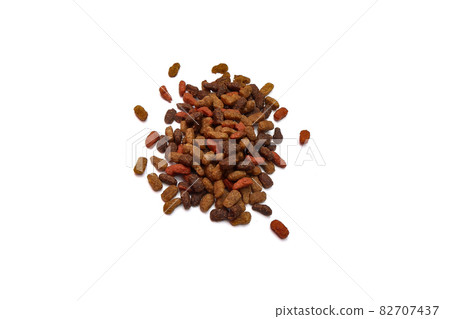 a little dry cat food lies isolated on a white background a little dry cat food lies isolated on a white background 82707437