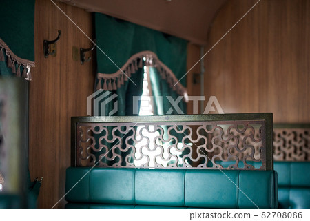 The interior of a steam-powered tourist retro train, stylized as Nikolaevskii Express and going along the route of Sortavala Ruskeala 82708086