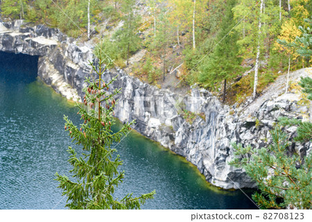 A former marble quarry in Ruskeala Mountain Park filled with groundwater and surrounded by an autumn forest A former marble quarry in Ruskeala Mountain Park filled with groundwater and surrounded by an autumn forest 82708123