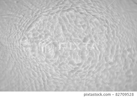 Water tranquil ripple background. Water texture, circles and bubbles on a liquid white surface. Cosmetic products and flat design concept 82709528