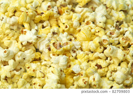 Popcorn on a colored background. Minimal food concept. Entertainment, film and video content. Aesthetics 80s and 90s concept 82709803