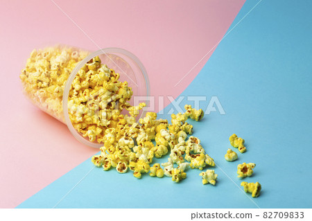Popcorn on a colored background. Minimal food concept. Entertainment, film and video content. Aesthetics 80s and 90s concept 82709833