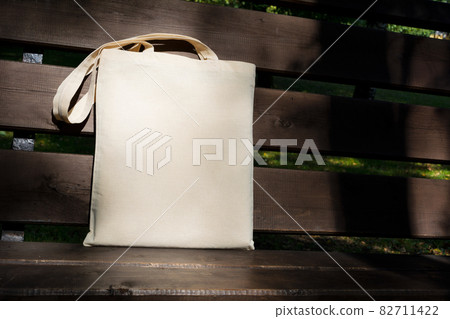 Canvas tote bag in the sunlight on the bench mockup Canvas tote bag in the sunlight on the bench mockup 82711422