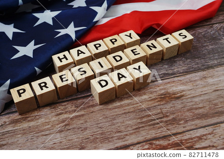 Happy Presidents Day Word alphabet letters with USA flag on wooden background 82711478