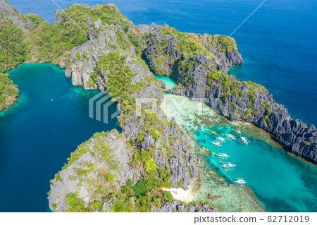 Aerial drone view azure sea and of tourist boats around the beautiful big and small lagoons in El Aerial drone view azure sea and of tourist boats around the beautiful big and small lagoons in El 82712019
