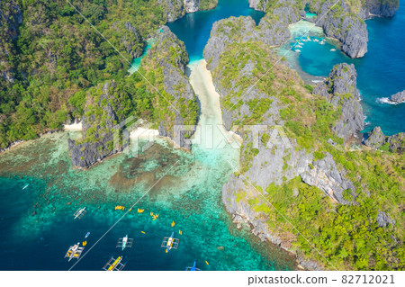 Aerial drone view azure sea and of tourist boats around the beautiful big and small lagoons in El Aerial drone view azure sea and of tourist boats around the beautiful big and small lagoons in El 82712021