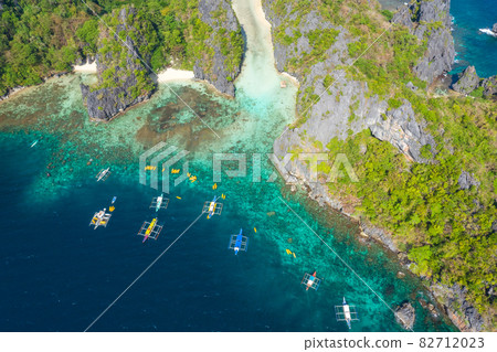 Aerial drone view azure sea and of tourist boats around the beautiful big and small lagoons in El Aerial drone view azure sea and of tourist boats around the beautiful big and small lagoons in El 82712023