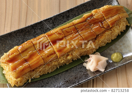 A bird's-eye view of sushi, gari and wasabi placed on bamboo leaves 82713258