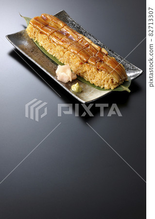 Conger eel placed on bamboo leaves Photographed sushi, gari and wasabi on a black background 82713307