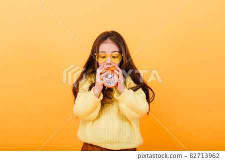 Cute little girl wearing bright stylish clothes on yellow colorful background Cute little girl wearing bright stylish clothes on yellow colorful background 82713962
