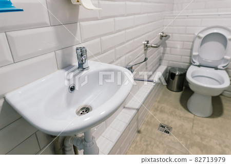 View of a new toilet and bathroom interior for hospital, white and clean View of a new toilet and bathroom interior for hospital, white and clean 82713979