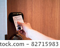 Hand Holding Key card Hotel for access the room 82715983