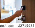 Hand Holding Key card Hotel for access the room 82715985