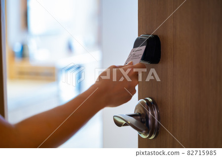 Hand Holding Key card Hotel for access the room 82715985