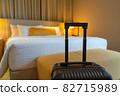 Suitcase and interior of hotel room 82715989