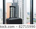 Suitcase and interior of hotel room 82715990