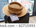 Passport and hat on suitcase in hotel room. concept of Travel and vacation 82715993