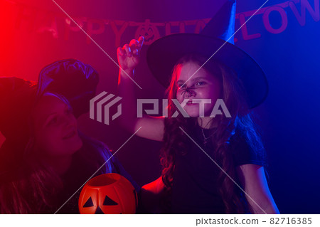 Funny child girl in witch costume for Halloween with spider. Funny child girl in witch costume for Halloween with spider. 82716385