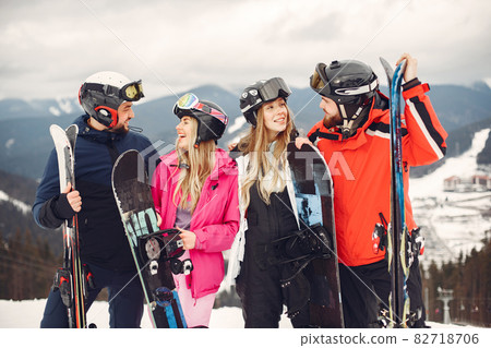 People snowboarding in the mountains with the snowboard 82718706