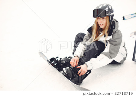 Girl snowboarding in the mountains with the snowboard Girl snowboarding in the mountains with the snowboard 82718719