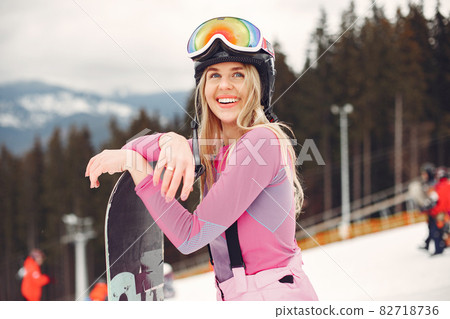 Girl snowboarding in the mountains with the snowboard Girl snowboarding in the mountains with the snowboard 82718736