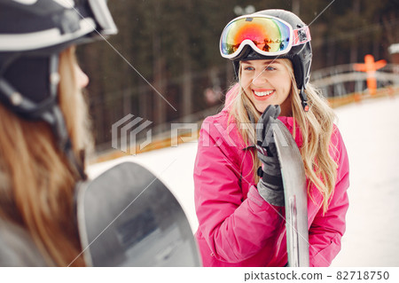 Girls snowboarding in the mountains with the snowboard 82718750
