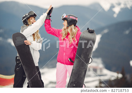 Girls snowboarding in the mountains with the snowboard 82718753