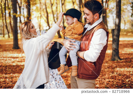 Beautiful and stylish family in a park Beautiful and stylish family in a park 82718966