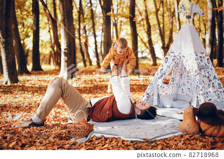 Beautiful and stylish family in a park Beautiful and stylish family in a park 82718968