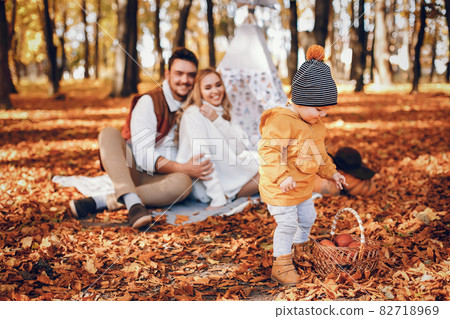 Beautiful and stylish family in a park Beautiful and stylish family in a park 82718969