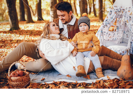 Beautiful and stylish family in a park Beautiful and stylish family in a park 82718971