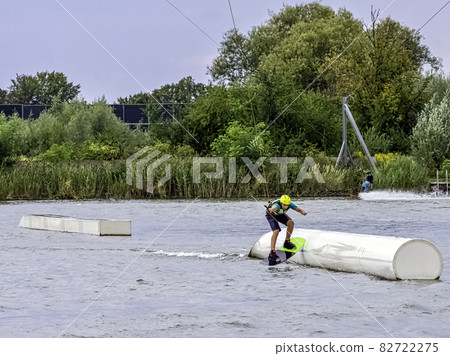 Teenager wakeboarding on a lake - Brwinow, Masovia, Poland 82722275