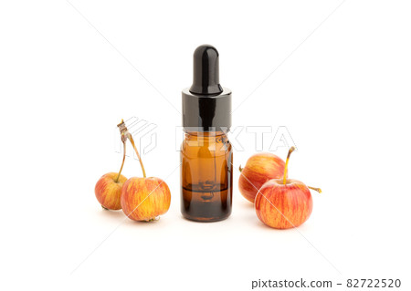 Apple essential oil isolated on white background. Apple oil 82722520