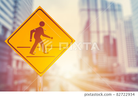 Traffic crosswalk sign on blur modern city office building background. Business people walking forward concept. Traffic crosswalk sign on blur modern city office building background. Business people walking forward concept. 82722934