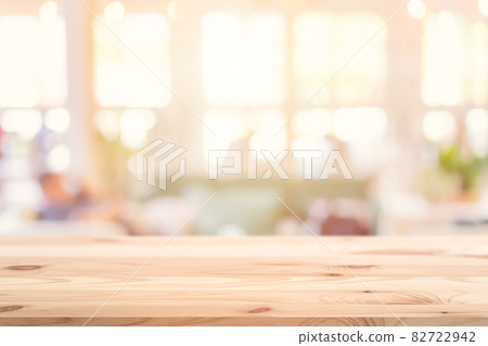 Wooden table top foreground with blurred indoor cafe shop and restaurant background for products display montage advertising banner. 82722942