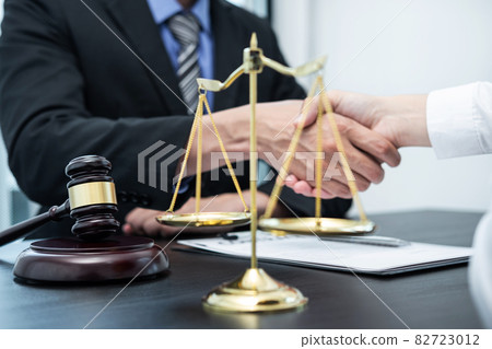 Male lawyer shaking hands with client after good deal negotiation cooperation meeting in courtroom 82723012