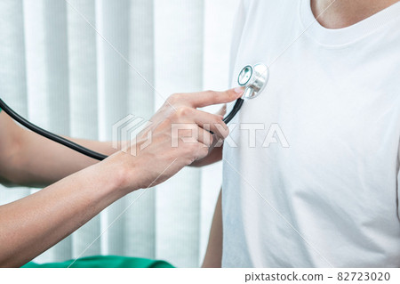 Doctor using a stethoscope checking patient about the problem of illness, sickness condition and recommend with examining treatment method 82723020