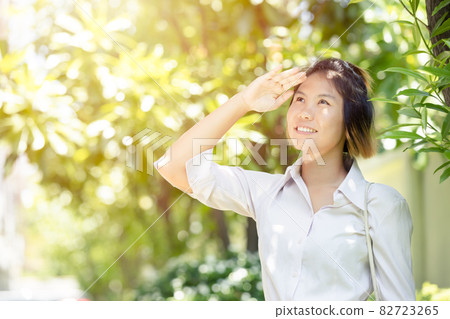 Women hand cover facial protection face skin damage from high UV sunlight outdoor. 82723265