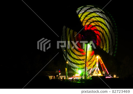 Artificial rainbow - Colorful carousel by night in Kempton Park, London, UK Artificial rainbow - Colorful carousel by night in Kempton Park, London, UK 82723469