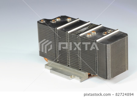 A close up view of passive CPU cooler with the aluminum fin and copper heat pipe structure isolate on white background. A close up view of passive CPU cooler with the aluminum fin and copper heat pipe structure isolate on white background. 82724894