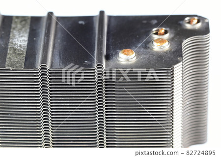 A close up view of passive CPU cooler with the aluminum fin and copper heat pipe structure isolate on white background. A close up view of passive CPU cooler with the aluminum fin and copper heat pipe structure isolate on white background. 82724895