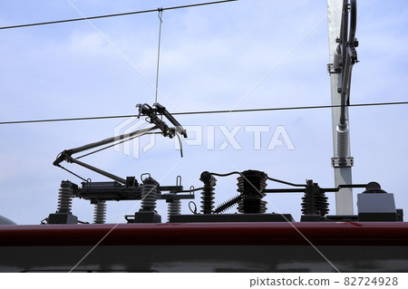 Pantograph of an electric train connecting the train to the overhead catenary wire 82724928