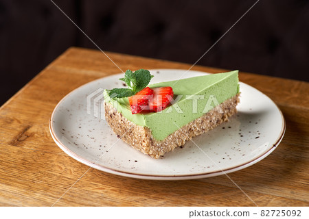 avocado lime cheesecake on a white wood background. toning. selective focus avocado lime cheesecake on a white wood background. toning. selective focus 82725092