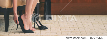 Shoe shopping woman trying on high heels shoes at home online buying fashion footwear stylish suede stilettos clothing panoramic banner header crop of women' s feet 82725669