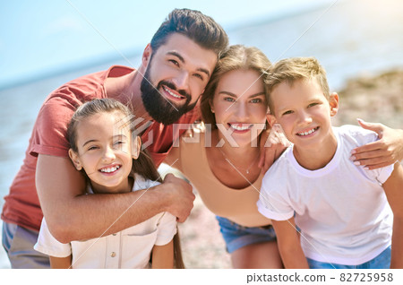 A picture of happy smiling family having fun on a beach 82725958