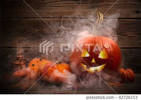 Halloween pumpkin head jack lantern on dark wooden background Halloween pumpkin head jack lantern on dark wooden background 82726153