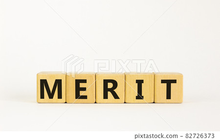 Merit symbol. The concept word 'merit' on wooden cubes on a beautiful white table. White background. Business and merit concept. Merit symbol. The concept word 'merit' on wooden cubes on a beautiful white table. White background. Business and merit concept. 82726373